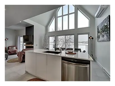 a kitchen with a sink and a counter top at Lakefront Spa - Chez Bernard L'Hermite in St-Ferdinand