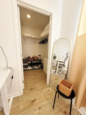 a walk in closet with a chair and a mirror at MTR Apart Montreal Hospital Corporate Stay in Longueuil