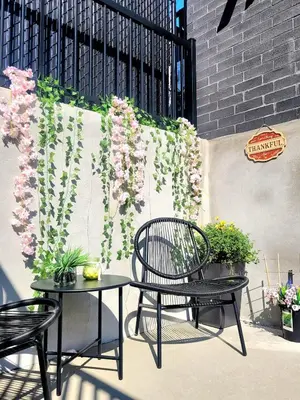 a patio with two chairs and flowers on a wall at MTR Apart Montreal Hospital Corporate Stay in Longueuil
