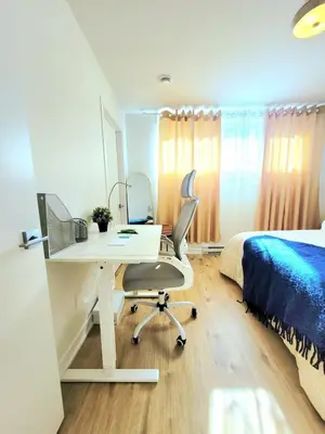 a bedroom with a desk and a bed at MTR Apart Montreal Hospital Corporate Stay in Longueuil
