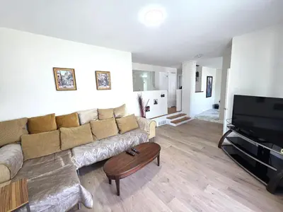 a living room with a couch and a flat screen tv at Warm Welcome Home in Longueuil