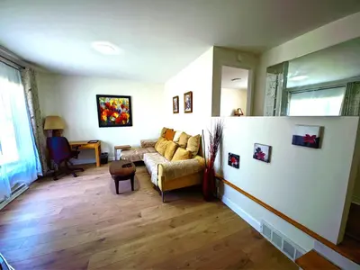 a living room with a couch and a table at Warm Welcome Home in Longueuil