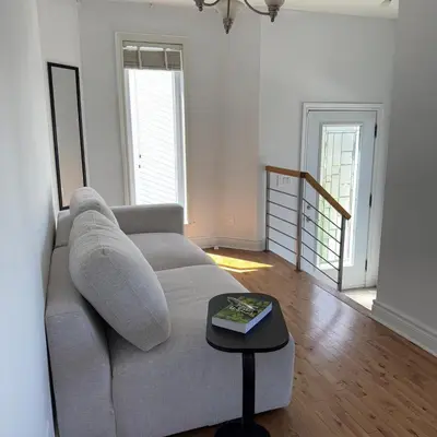 a living room with a couch and a table at Apartment 3 chambres near Montréal in Sainte-Catherine