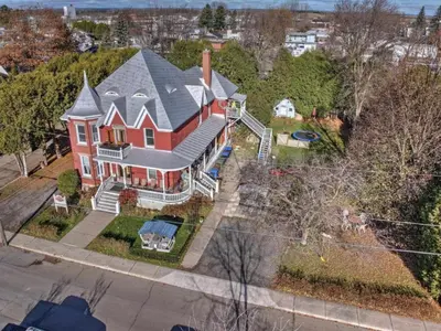 an aerial view of a large red house at La Victorienne in Louiseville