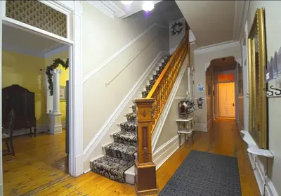 a staircase in a house with a stair case at La Victorienne in Louiseville