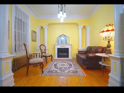 a living room with a couch and a fireplace at La Victorienne in Louiseville