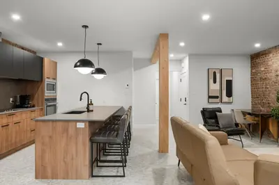 an open kitchen and living room with a bar and chairs at SD5 Harmony sur le plateau in Montréal