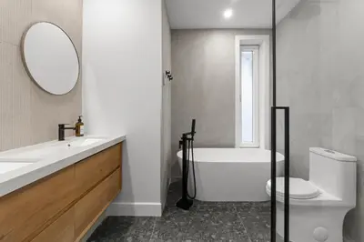 a bathroom with a tub and a toilet and a mirror at SD5 Harmony sur le plateau in Montréal