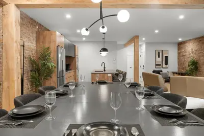 a dining room with a table with wine glasses at SD5 Harmony sur le plateau in Montréal
