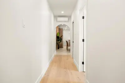 an empty hallway with white walls and wooden floors at SD5 Harmony sur le plateau in Montréal