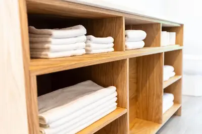 a wooden shelf with towels in a bathroom at By the river - Le 91 in Frelighsburg