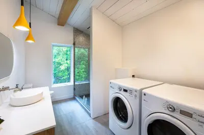 a laundry room with a washer and dryer at By the river - Le 91 in Frelighsburg