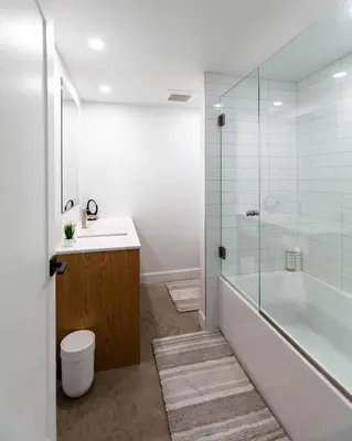 a bathroom with a tub and a sink and a shower at By the river - Le 91 in Frelighsburg