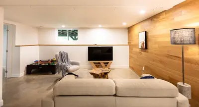 a living room with a couch and a tv at By the river - Le 91 in Frelighsburg