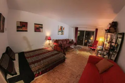 a bedroom with a bed and a living room at Studio, balcony, pool view, sauna in Montréal