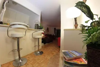 a living room with a hair dryer in a room at Studio, balcony, pool view, sauna in Montréal