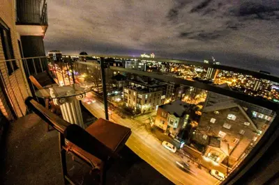 a view of a city at night from a balcony at Studio, balcony, pool view, sauna in Montréal
