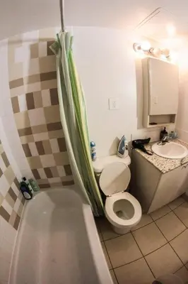 a bathroom with a toilet and a sink at Studio, balcony, pool view, sauna in Montréal
