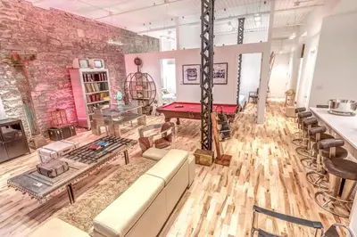 a living room with a pool table and a brick wall at Old Port Elegance and Designer Loft with PV Terrace in Montréal