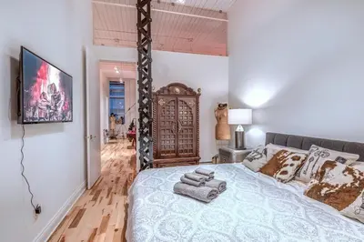 a bedroom with a large bed with towels on it at Old Port Elegance and Designer Loft with PV Terrace in Montréal