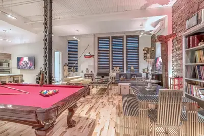 a room with a pool table and a brick wall at Old Port Elegance and Designer Loft with PV Terrace in Montréal