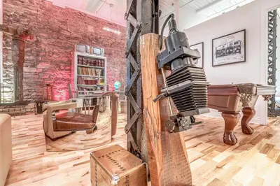 a room with a piano and a brick wall at Old Port Elegance and Designer Loft with PV Terrace in Montréal