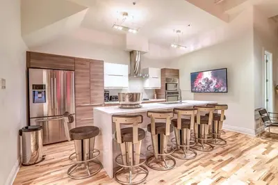 a kitchen with a island with bar stools at Old Port Elegance and Designer Loft with PV Terrace in Montréal
