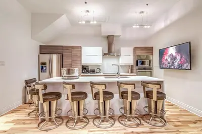 a kitchen with a island with bar stools at Old Port Elegance and Designer Loft with PV Terrace in Montréal