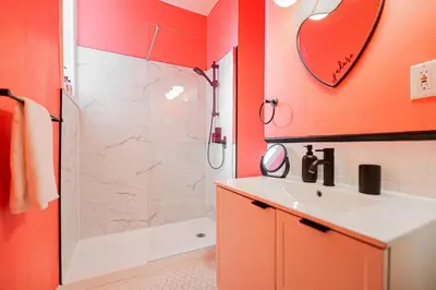 a bathroom with orange walls and a sink and a shower at Unique Downtown Montreal Stay with Private Terrace in Montréal