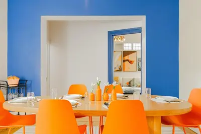 a dining room with a table and orange chairs at Unique Downtown Montreal Stay with Private Terrace in Montréal