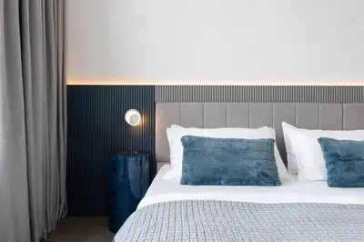 a bedroom with a bed with blue and white pillows at Modern Design - Newly renovated apartment with a view and parking in Montréal