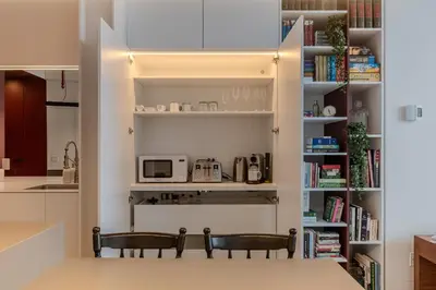 a kitchen with two chairs and a counter with a microwave at Modern Design - Newly renovated apartment with a view and parking in Montréal