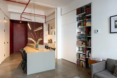 a dining room and living room with a table and a book shelf at Modern Design - Newly renovated apartment with a view and parking in Montréal