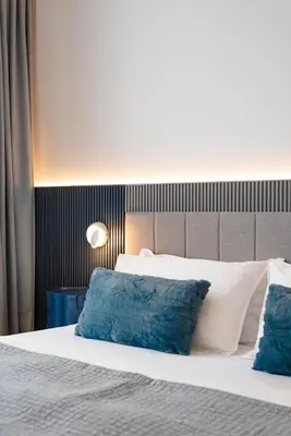 a bedroom with a white bed with blue pillows at Modern Design - Newly renovated apartment with a view and parking in Montréal