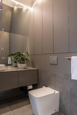 a bathroom with a white toilet and a sink at Modern Design - Newly renovated apartment with a view and parking in Montréal
