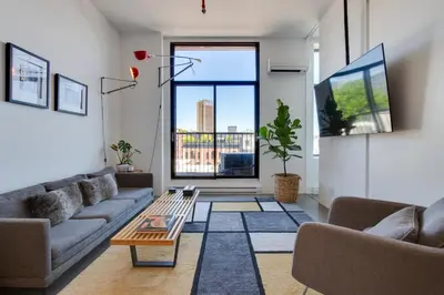 a living room with couches and a large window at Modern Design - Newly renovated apartment with a view and parking in Montréal