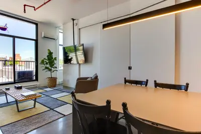 a meeting room with a table and chairs at Modern Design - Newly renovated apartment with a view and parking in Montréal