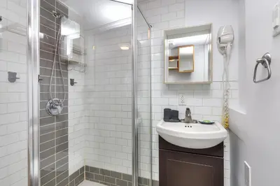 a bathroom with a sink and a shower at Fox Aparthotel - Palais Des Congres in Montréal