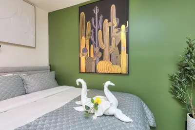 two white swans sitting on a bed in a bedroom at Fox Aparthotel - Palais Des Congres in Montréal