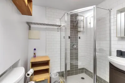 a bathroom with a shower and a toilet and a sink at Fox Aparthotel - Palais Des Congres in Montréal