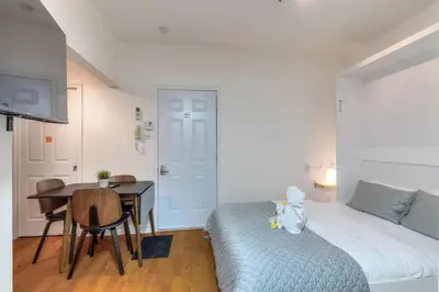 a bedroom with a bed and a table and a desk at Fox Aparthotel Palais Des Congres V in Montréal