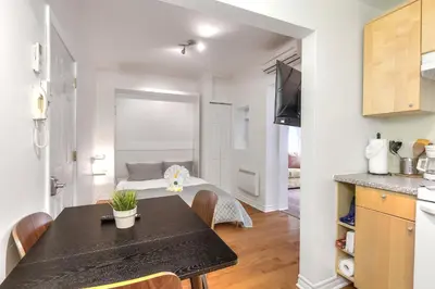 a kitchen and dining room with a table in a room at Fox Aparthotel Palais Des Congres V in Montréal