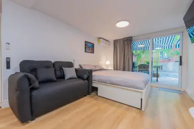 a bedroom with a bed and a couch at Modern Studio-Patio & BBQ-Parking Included in Montréal