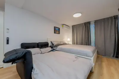 two beds sitting next to each other in a room at Modern Studio-Patio & BBQ-Parking Included in Montréal