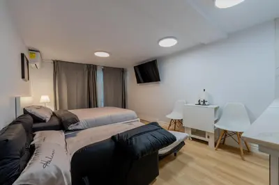 a living room with two beds and a couch at Modern Studio-Patio & BBQ-Parking Included in Montréal