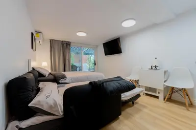 a living room with a couch and a bed at Modern Studio-Patio & BBQ-Parking Included in Montréal