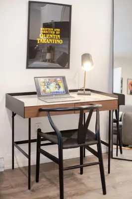 a desk with a laptop computer on top of it at Theatre Hotel by Lodgo in Montréal