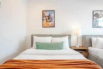 a bedroom with a bed with an orange blanket at Theatre Hotel by Lodgo in Montréal