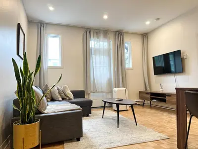 a living room with a couch and a tv at Lovely One-Bedroom in Vibrant Plateau Mont-Royal in Montréal