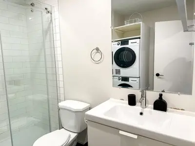 a bathroom with a toilet and a sink and a microwave at Lovely One-Bedroom in Vibrant Plateau Mont-Royal in Montréal
